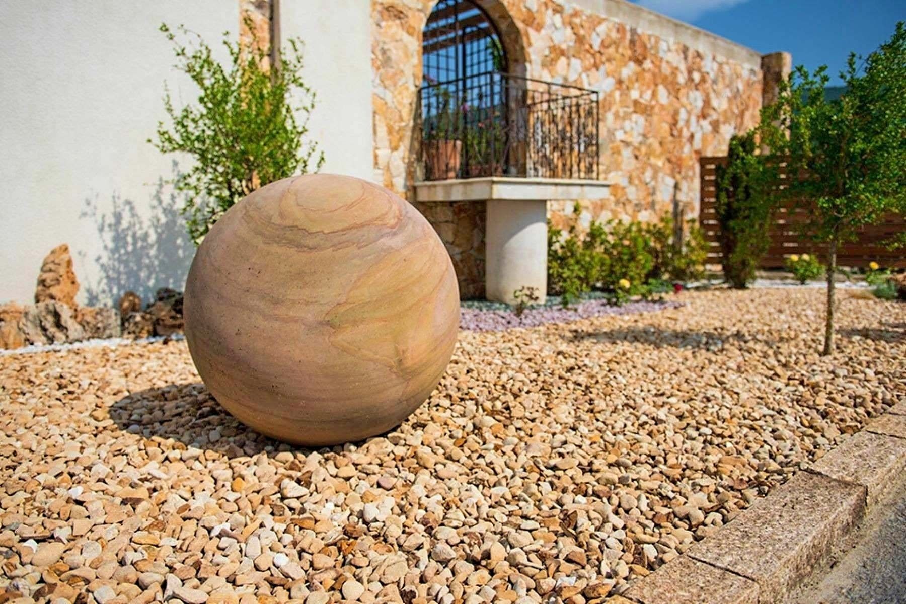 sandstone garden edging with sandstone pebbles and sandstone sculpture