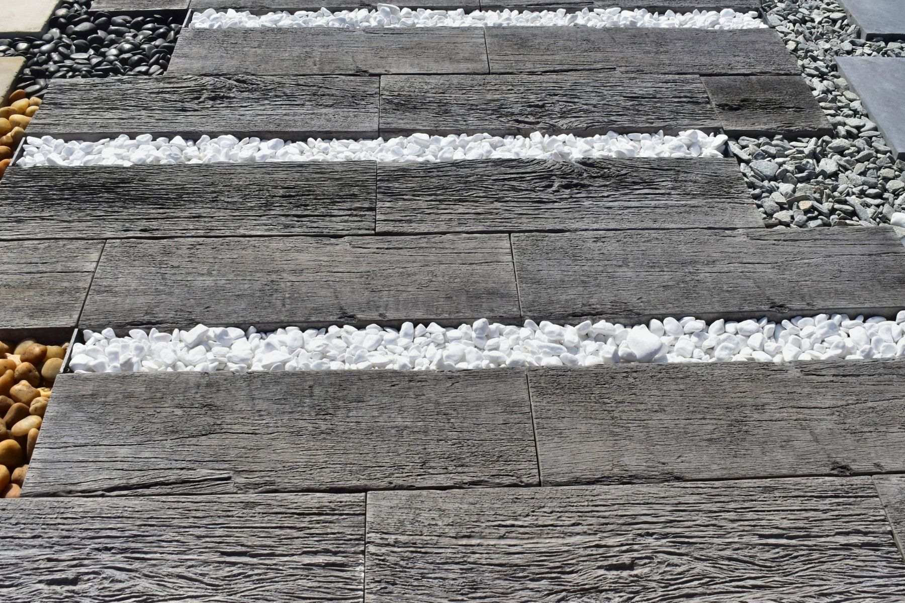 timber look pavers with a weathered antique look contrasting white stones in between
