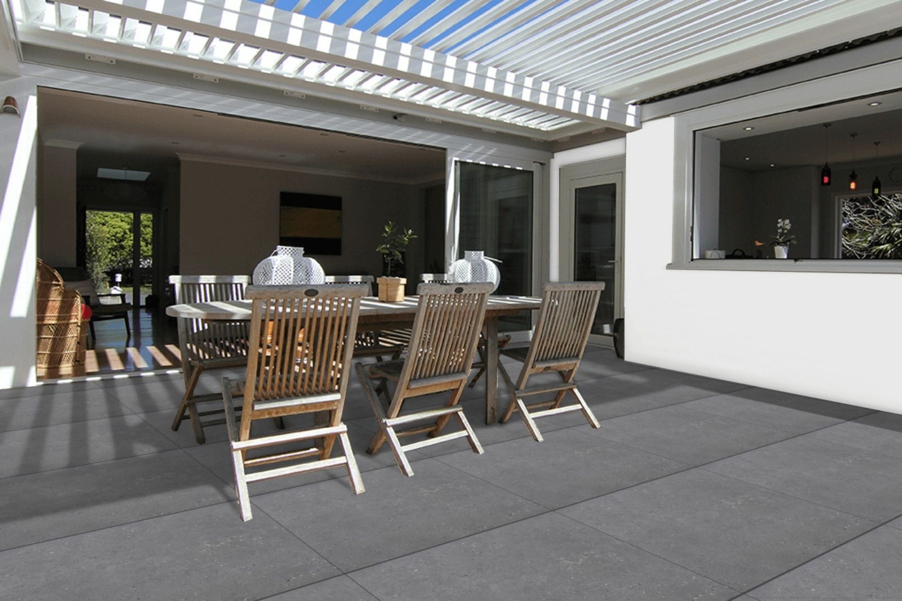 grey natural stone porcelain pavers used under opening pergola with outdoor dining set