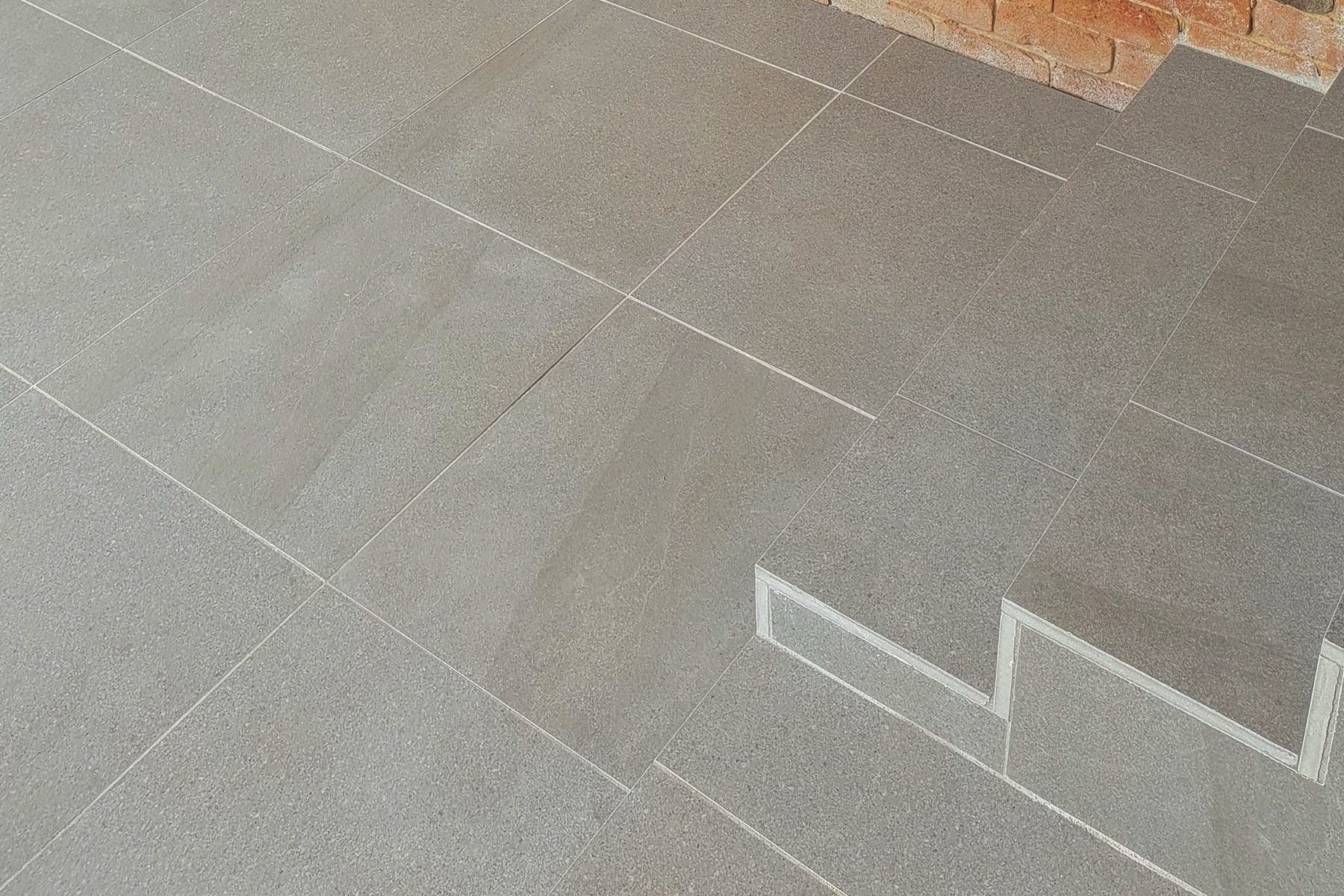 grey porcelain pavers used as step pavers with landing looking like natural stone tiles