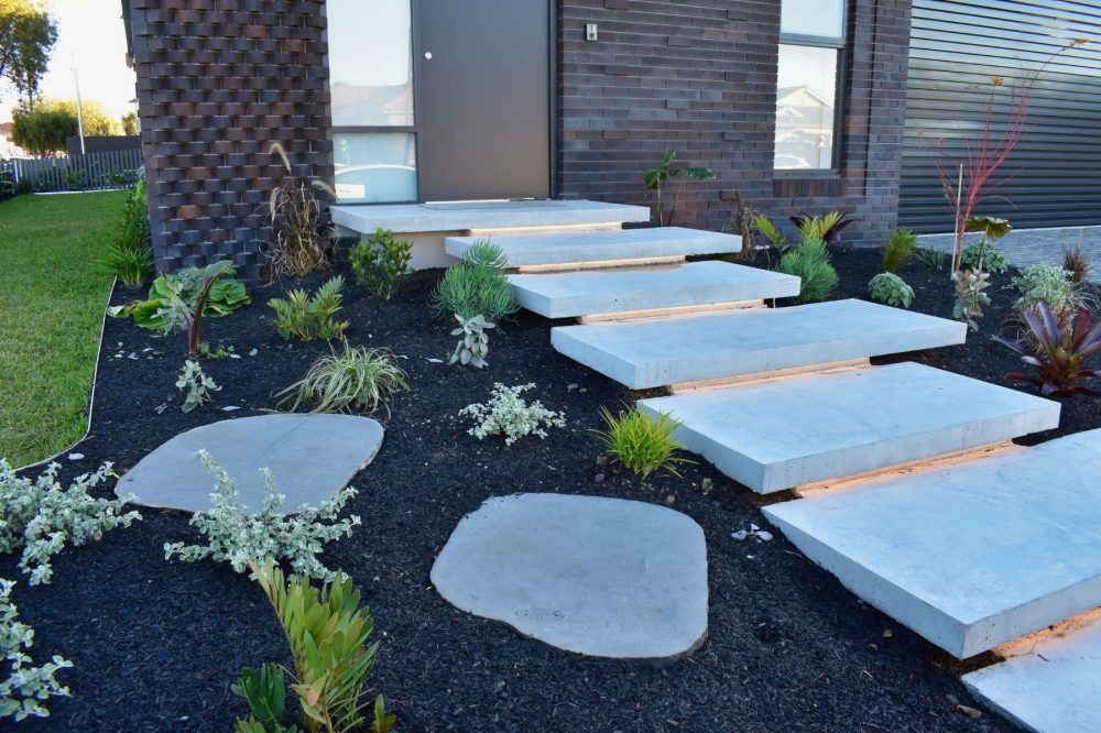organic stepping stones in bluestone at front of house